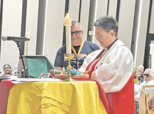 Indigenous man and woman at an altar preparing it for a Euchrist
