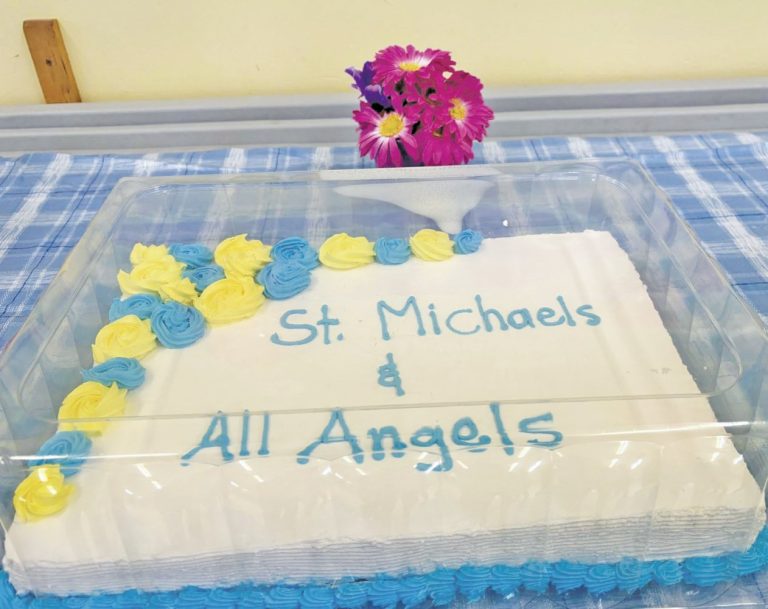 a cake decorated to say "St. Michaels & All Angels in blue icing