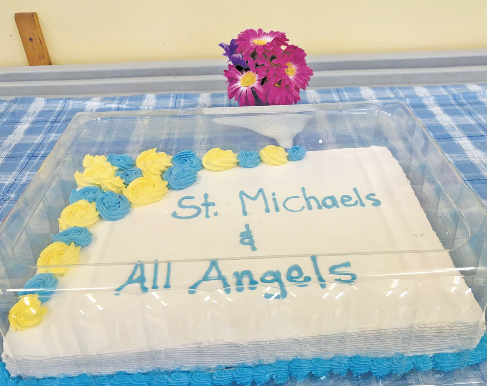 a cake decorated to say "St. Michaels & All Angels in blue icing