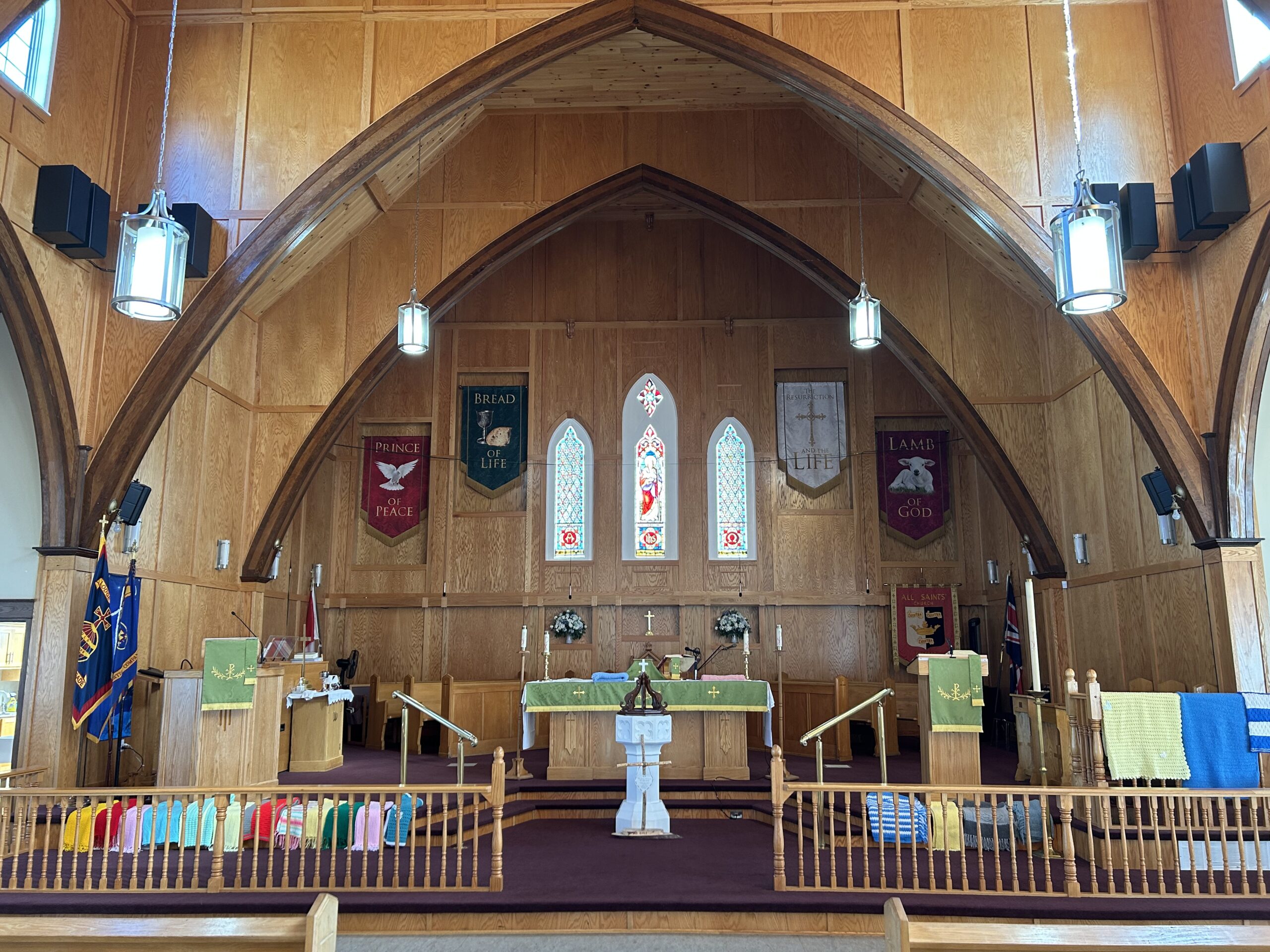 prayer shawl draped over the communion rail at the front of a wooden church