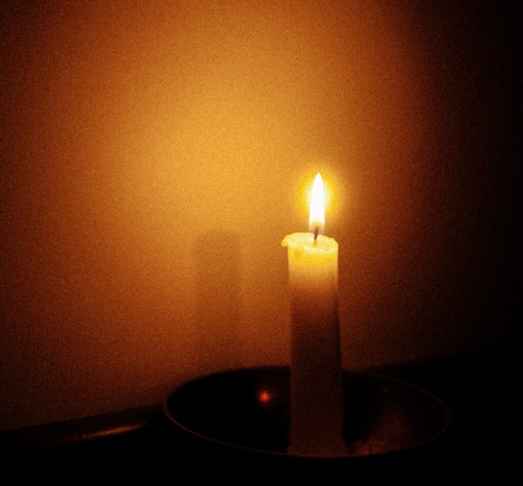 candle burning in a dark room