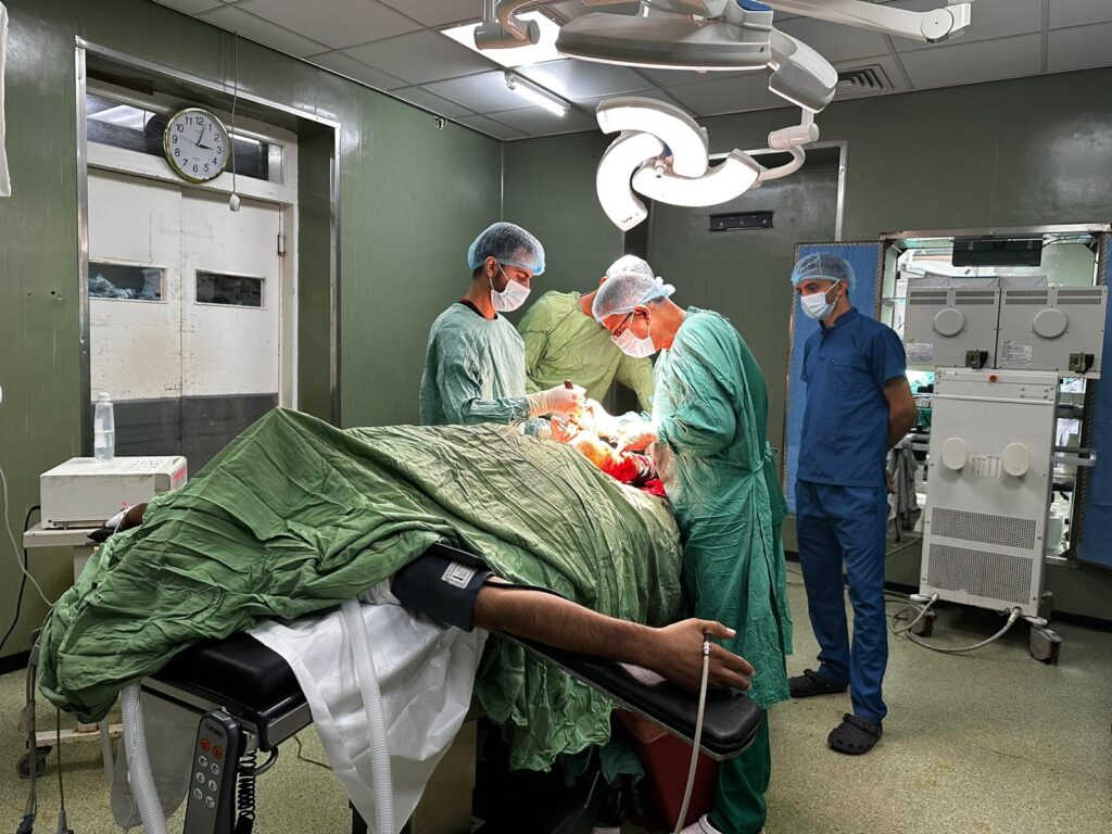 Surgeons performing operation in operating room.
