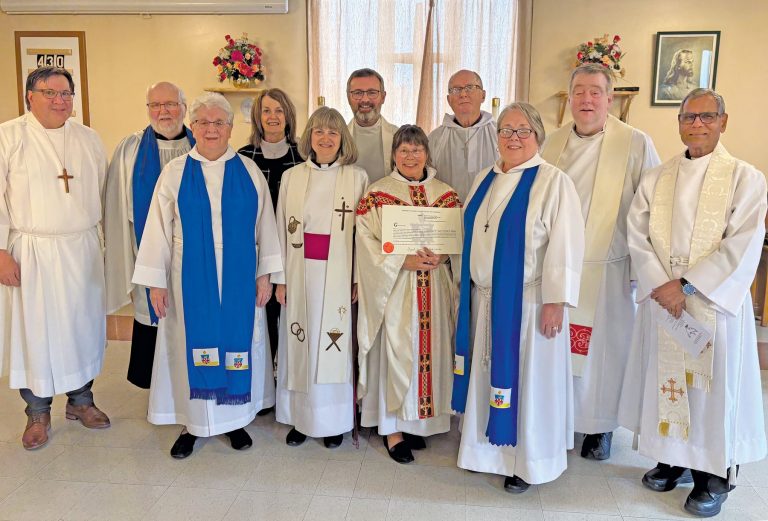 a group of 11 people, all dressed in anglican church vestments