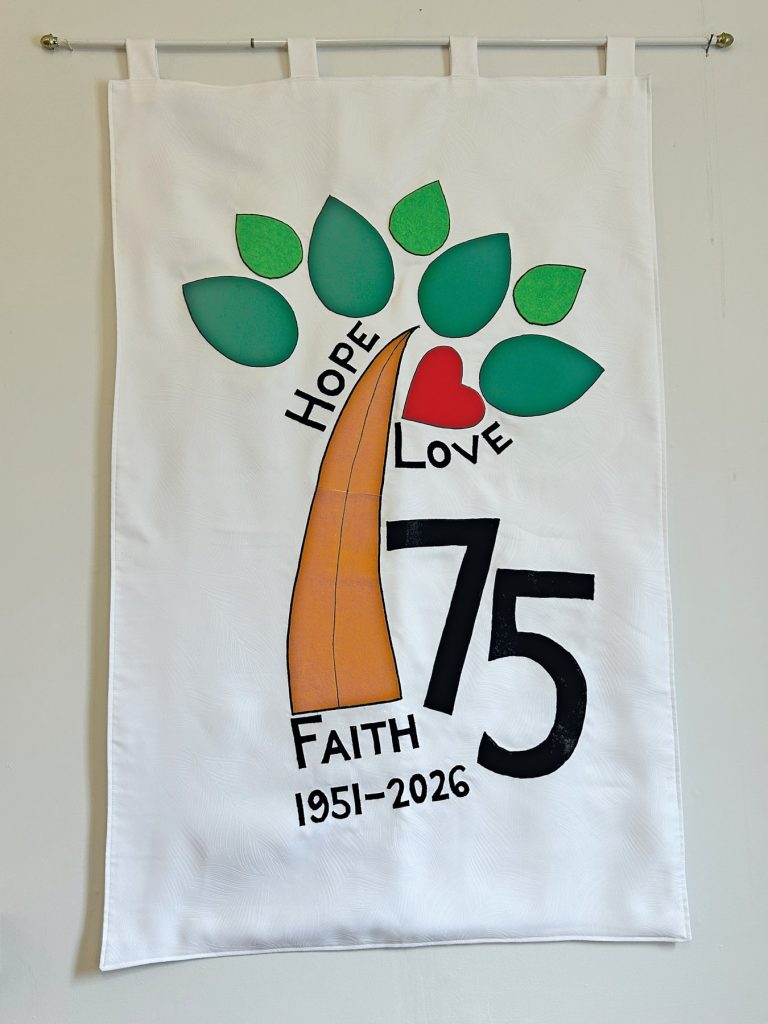 a banner of a tree with the number 75 on it and "Hope," "Love," and "Faith" on it with the years "1951-2026"