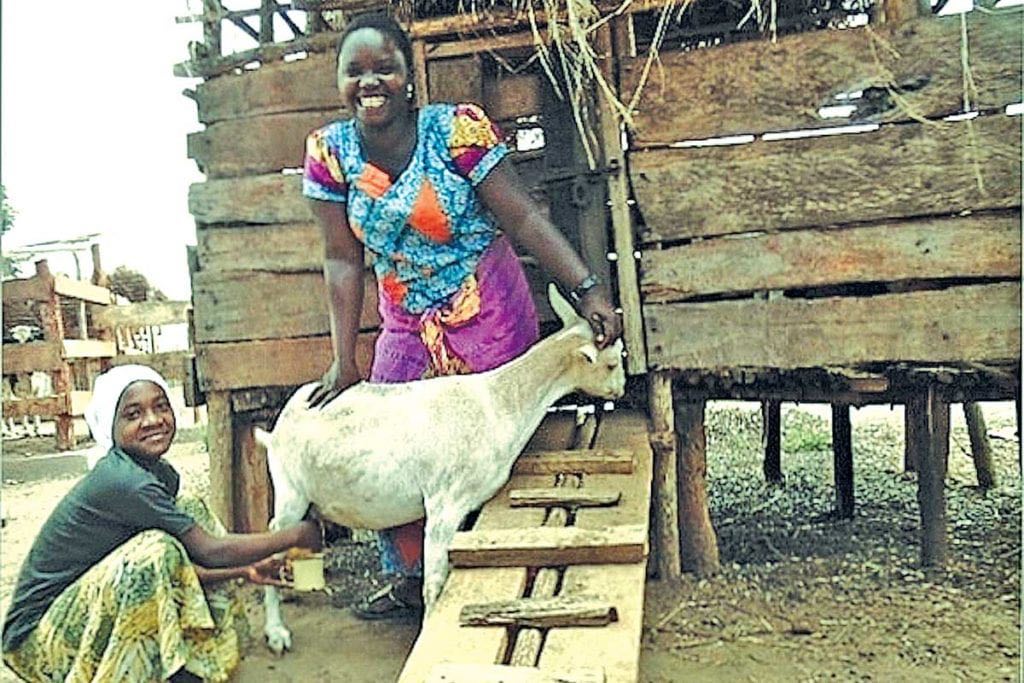 Photo of two women with a goat