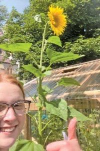 Claire Donnan poses with a sunflower