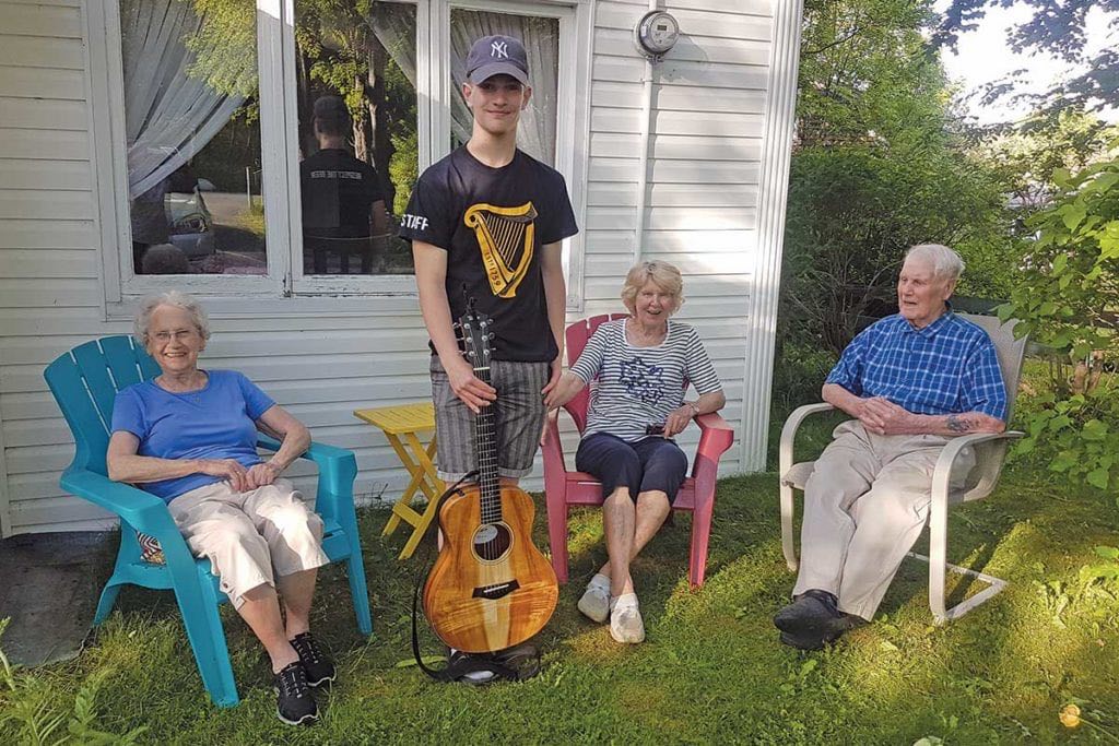 Darcy Scott visits Cec and Edna Warford of Upper Gullies for a safe outside visit this past summer. Left-right are: Edna, Darcy, Cynthia Dawe (family friend) and Cec.
