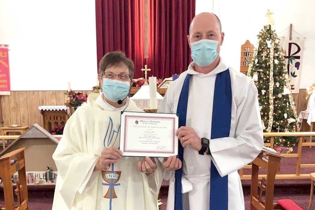 Greg Loder receives his certificate of appreciation from Rev’d Kay