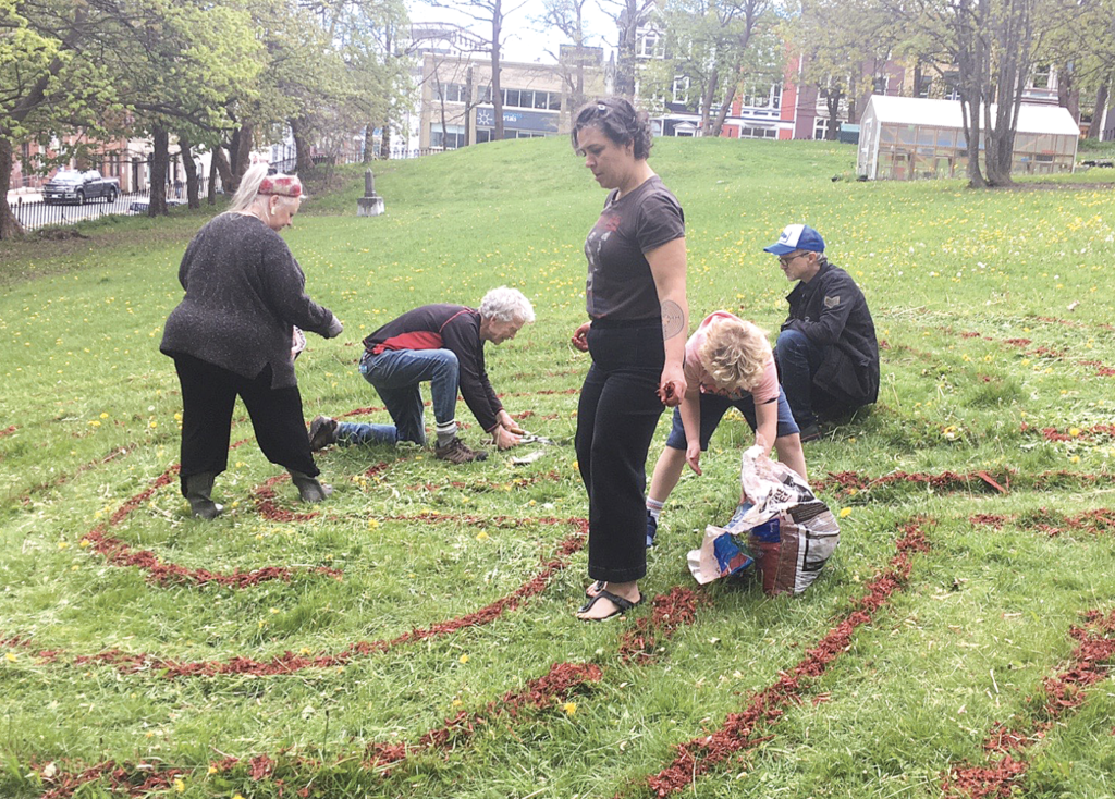 people re-establishing the labyrinth in the cathedral yard in St. John's
