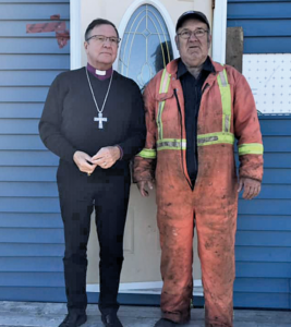 bishop and man survey damage after hurricane Fiona