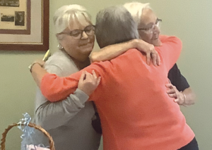 woman hugging two other women